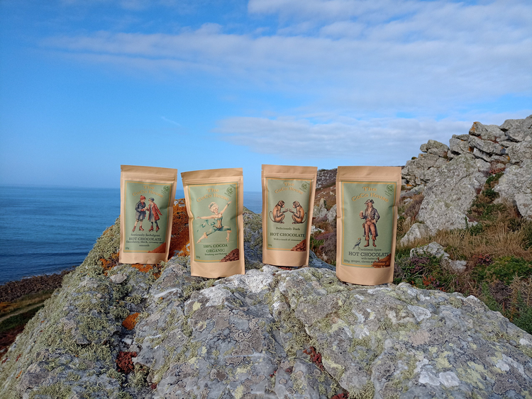 Four types of Coco House hot chocolates balanced on rocks by the seaside Dinan France